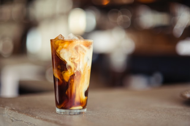 7 Fail-Proof Tips For Making Cold Brew Coffee At Home 8 glass of cold brew with milk flowing through on concrete table, dilute cold brew, cold brew concentrate