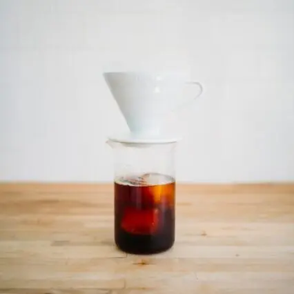 Pour over dripper brewing into glass of ice, how to make japanese iced coffee