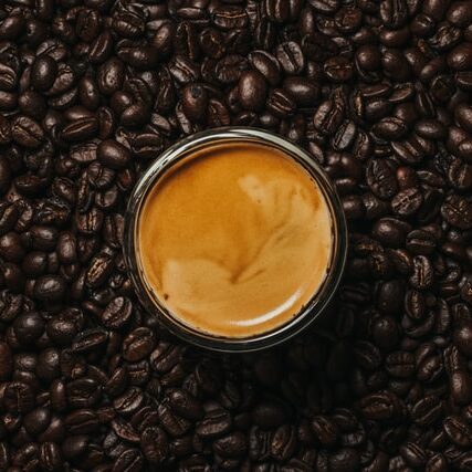 espresso shot sitting in coffee beans, best beans for espresso, best espresso beans