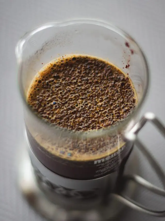 How To Use French Press Coffee Makers + The #1 Mistake 9 looking down into a Melita French press with grounds floating on top