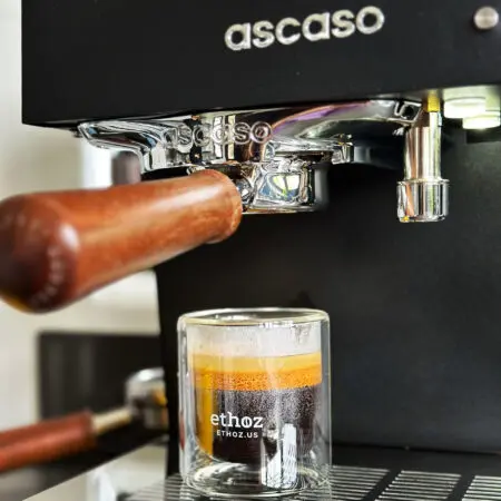 triple shot of espresso in glass cup on espresso machine tray