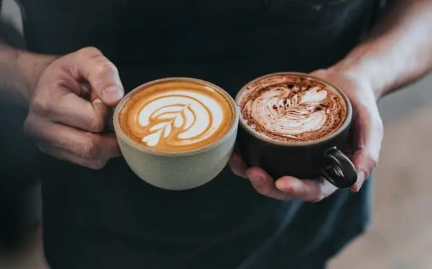 barista holding a latte and a mocha, latte vs. mocha
Difference between a latte and a mocha
Mocha or latte