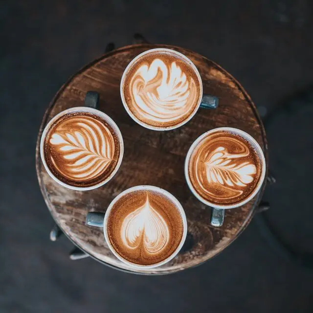 four espresso drinks on a wood table from above
Espresso drink types
Flat white vs cortado
