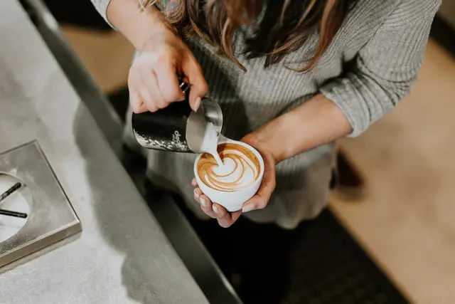 barista pouring milk into flat white coffee
How to make a flat white coffee
