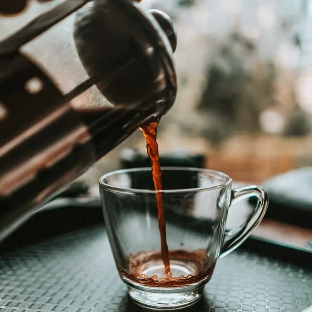 How To Use French Press Coffee Makers + The #1 Mistake 10 French press pouring coffee into clear mug on tray