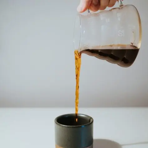 pouring pour over coffee into stemless mug, drip coffee vs. pour over, drip coffee vs pour over