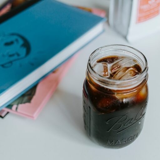 mason jar of cold brew beside books, is cold brew coffee strong