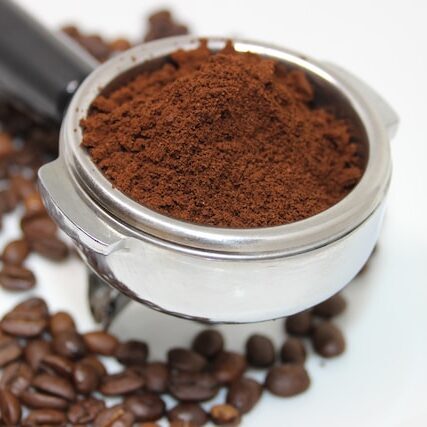 portafilter with ground coffee, grinding coffee, grind of coffee