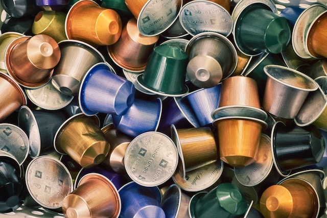 Nespresso pods of various colors in a pile close up