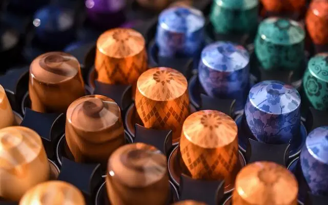 rows of colorful Nespresso pods close up, reusing Nespresso pods