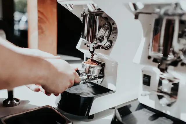 barista grinding espresso into portafilter