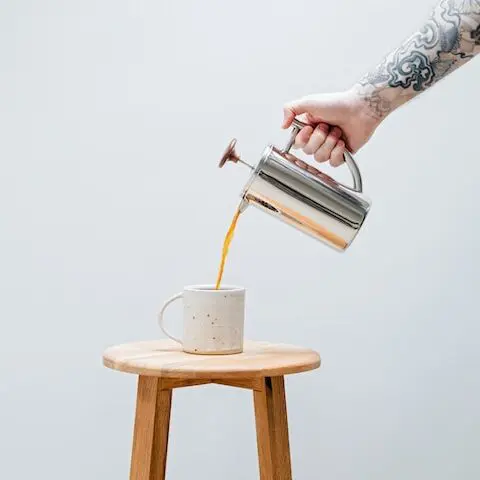 coffee for french press, pouring french press coffee into white mug