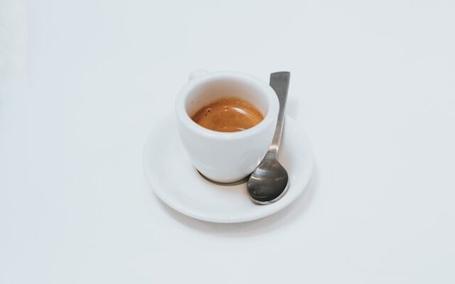 Ristretto shot in white demitasse with saucer and spoon