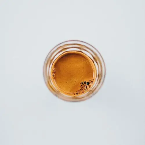 How Much Caffeine is in a Shot of Espresso? +5 Proven Facts 2 looking down into glass with espresso shot